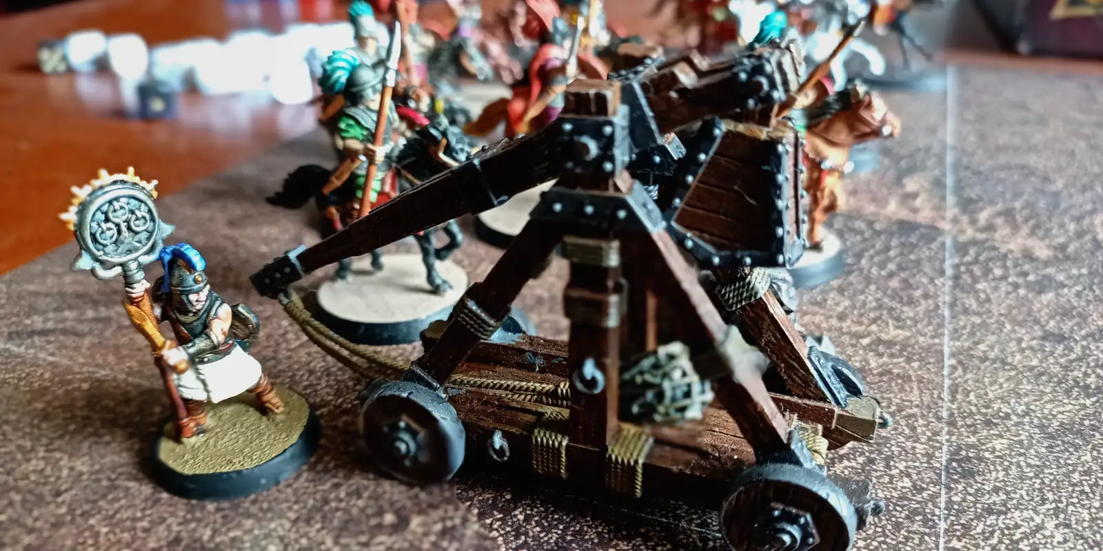 A roman soldier manning a catapult.